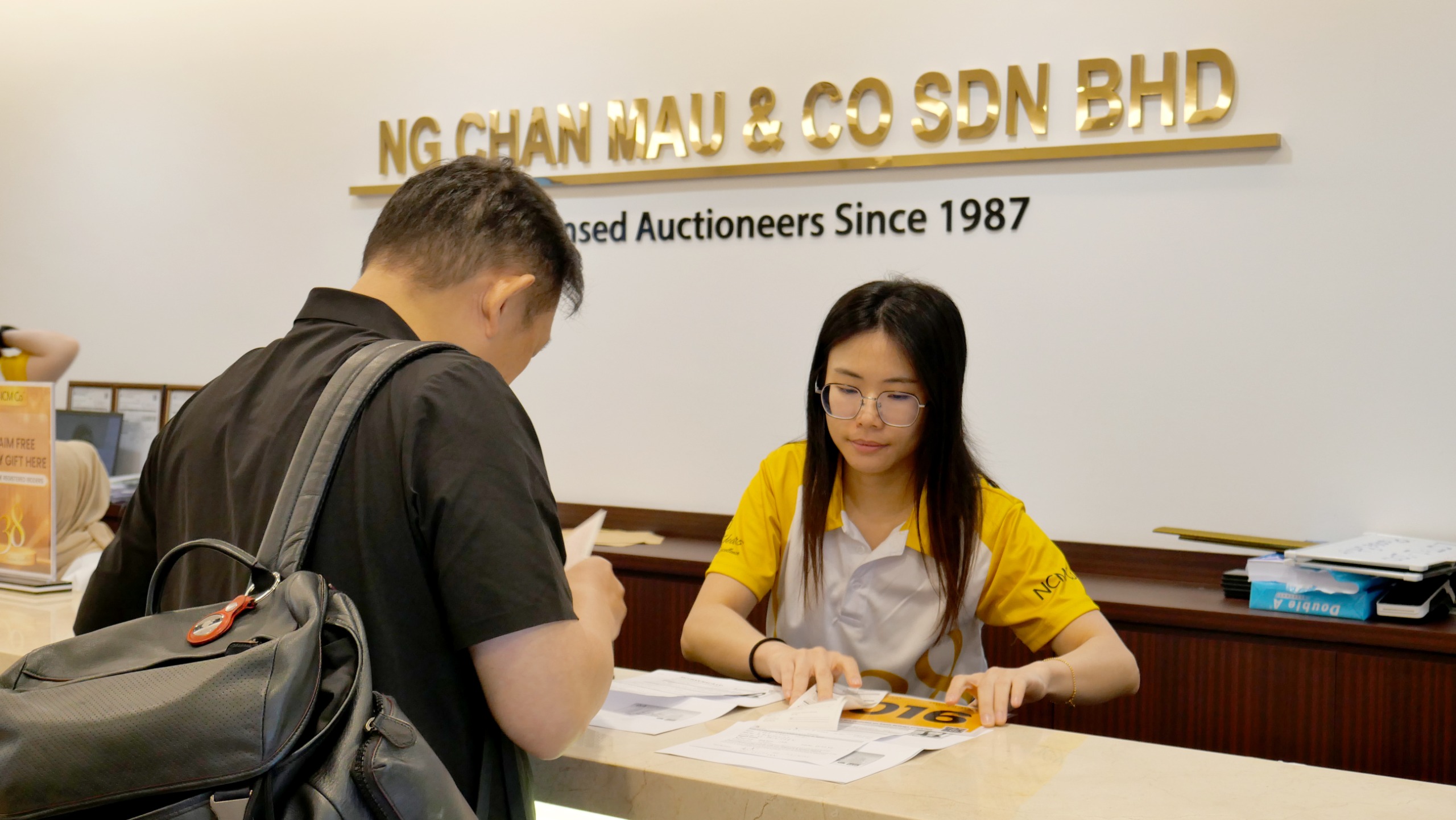 Customer reviewing auction documents